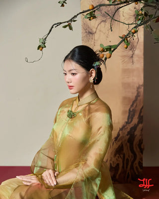 Vẻ đẹp áo dài cách tân Bảo Thạch họa tiết hoa sắc vàng kim và xanh lá, sản phẩm của nhà may áo dài La Hằng